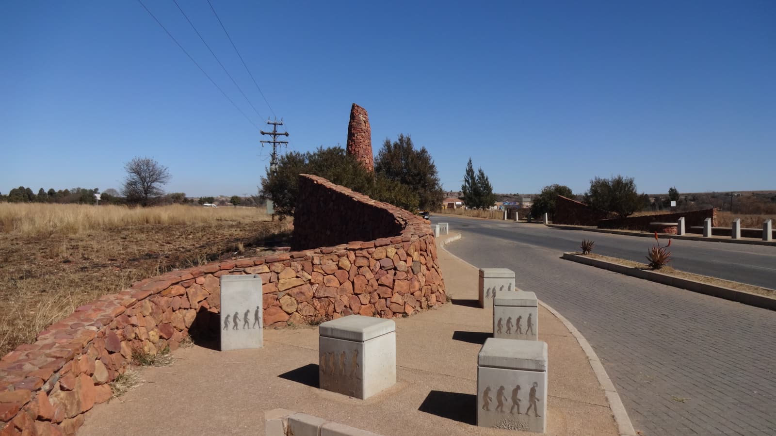 Road and stone gateway markers on the way into the Cradle of Humankind